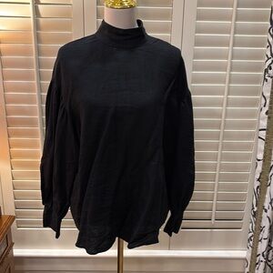 Black Linen blouse with puff sleeves and tortuous buttons.